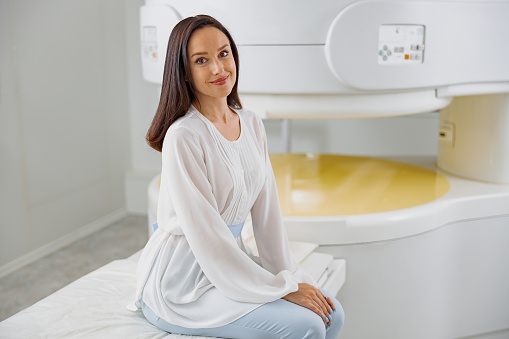 Patient after doing magnetic resonance imaging MRI or CT scan. High-Tech modern medical equipment