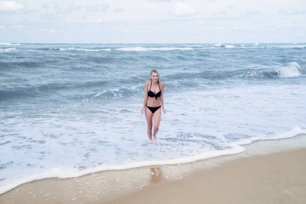 istock girl on winter sea 1403505295