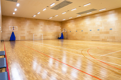 Interior of empty modern basketball or soccer indoor sport gymnasium
