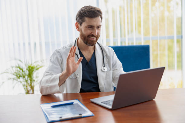 istock Therapist conducts video consultations, communicates with the patient through call by laptop 1403508109