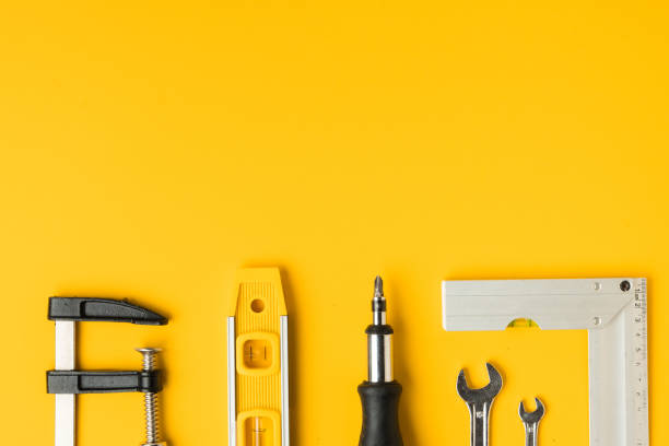 istock Handyman's tools. Flat lay of clamps, wrench, screwdriver, drill, angle, bubble level and tape measure on yellow background. Happy Father's Day. Free space  for you text 1403510834