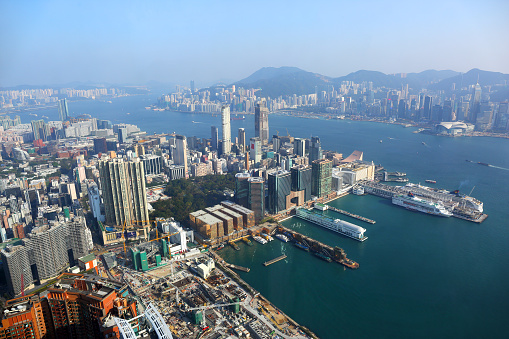 Hong Kong aerial view with urban skyscrapers boat and sea