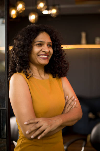 istock Happy woman looking out through glass window 1403514055