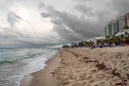 Fort Lauderdale, Florida, USA - May 30, 2022: Beachgoers on the sand at Sebastian Street Beach, the gay section of Fort Lauderdale Beach in Fort Lauderdale, Florida.