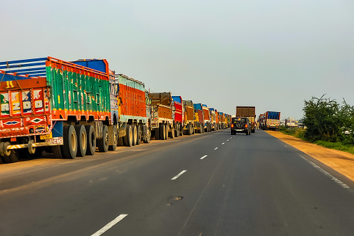 Kolkata WB India - May 25, 2022 : Taken this picture in the summer afternoon of the national highway outside Kolkata. Numerous trucks parked beside the highway.