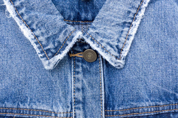 istock Turn-down collar of a blue denim jacket, close-up. 1403518986