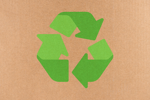 Water damaged cardboard box with pictograms. Recycled symbols for packaging materials