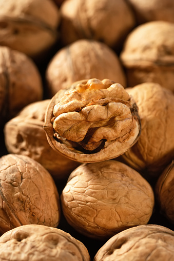 Walnut kernel and whole nuts on the market. Background of fresh walnuts.
