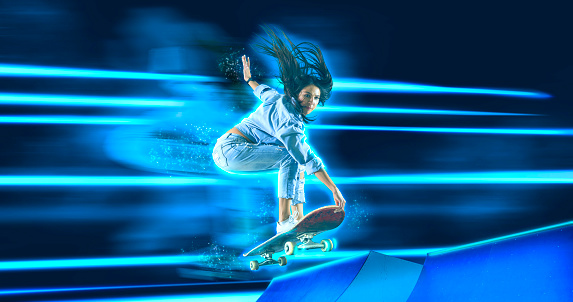 Skateboarder doing trick on neon background. Freestyle extreme sports concept. Sports banner