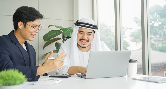 close up group of asian businessmen talking with Arab investor about global investment project in board room for working multiracial group concept