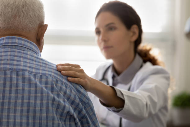 istock Serious GP doctor giving support to elderly patient 1403523127