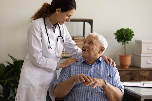 istock Happy doctor giving hug and support to optimistic old patient 1403523135