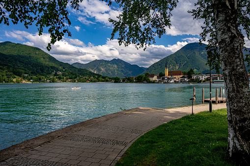 Park or garden with Scenic view of mountains and lake in the background.
