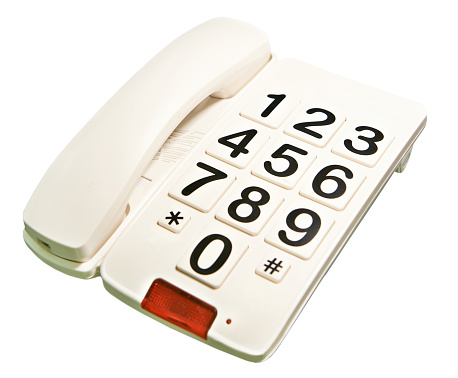 Landline telephone with large buttons and numbers isolated white background
