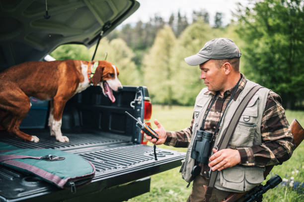 istock Man preparing for a hunt with his hunting dog. 1403526535