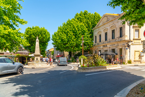 A water fountain on a charming picturesque street of shops and cafes in the historic medieval village town of Saint-Remy-de-Provence in the Provence Cote d'Azur region of Southern France.