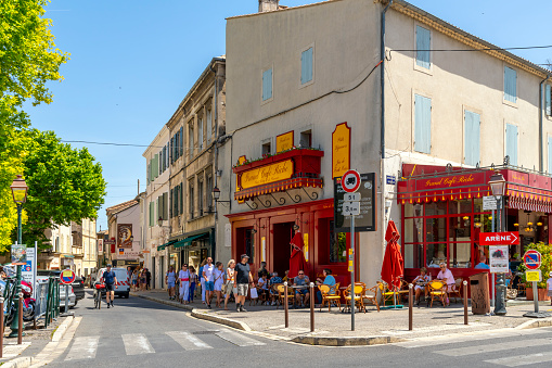 A charming picturesque street of shops and cafes in the historic medieval village town of Saint-Remy-de-Provence in the Provence Cote d'Azur region of Southern France.
