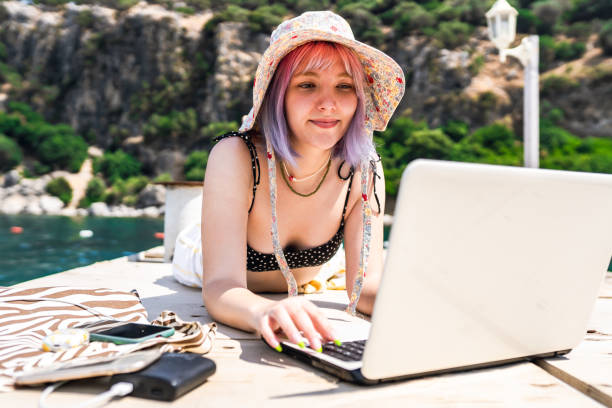 istock Young woman with colored hair working remotely on vacation 1403529095