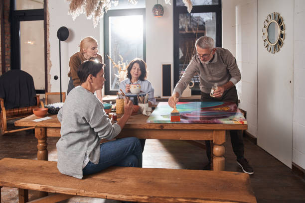 istock Mature man putting fresh paints into the canvas while creating his own masterpiece 1403529717