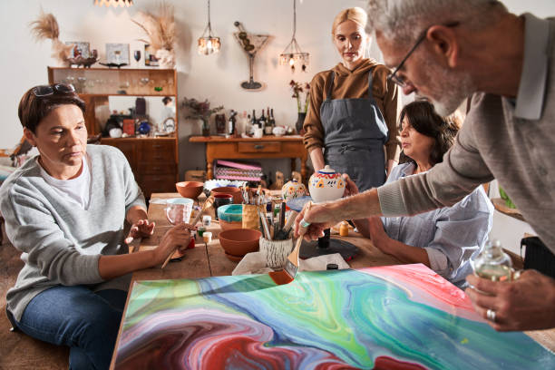 istock Man drawing vivid abstract fresh masterpiece with wet paints at the art master class 1403529726