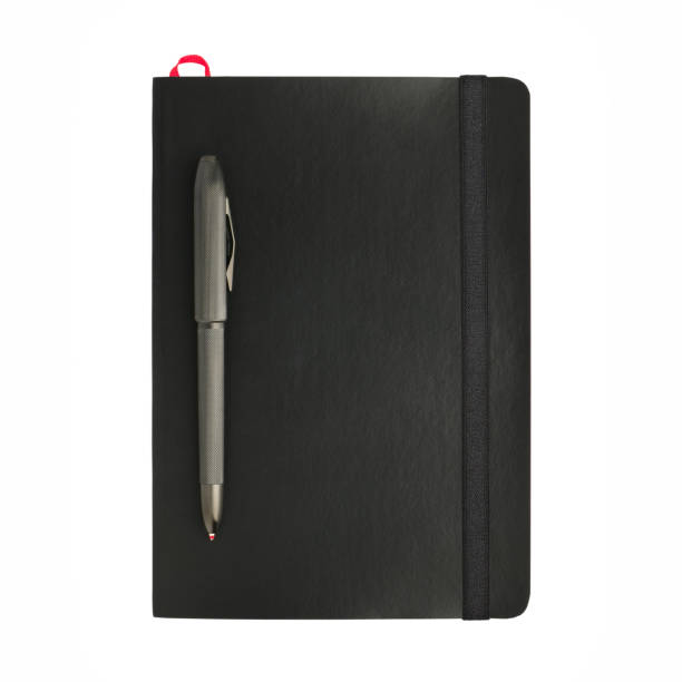 istock Black business diary and chic ballpoint pen isolated on white background 1403530401