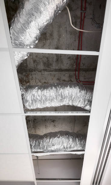 istock Ventilation pipes in silver insulation material in suspended ceiling during renovation. 1403532596