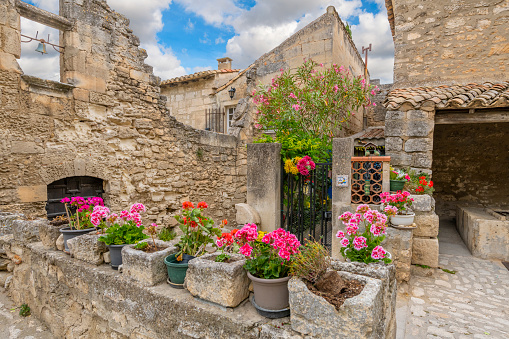 Colorful flowers and plants on a street in the ancient village of Les-Baux-de-Provence, France.