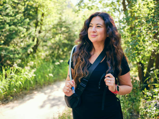 A woman enjoying active lifestyle time outdoors in a nature environment.