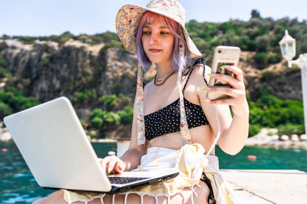 istock Young woman with colored hair working remotely on vacation 1403532926