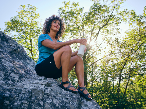 A woman enjoying active lifestyle time outdoors in a nature environment.