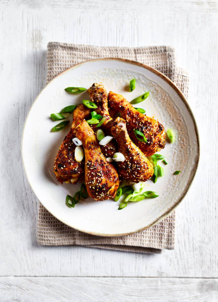 istock Roasted chicken legs with sesame seeds and spring onion on the plate 1403533640