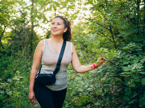 A woman enjoying active lifestyle time outdoors in a nature environment.