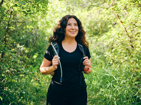 A woman enjoying active lifestyle time outdoors in a nature environment.