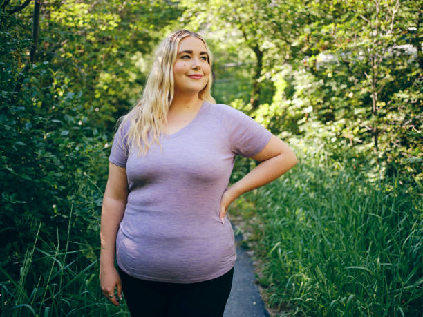 Woman Enjoying an Active Lifestyle A woman enjoying active lifestyle time outdoors in a nature environment. plus size stock pictures, royalty-free photos & images