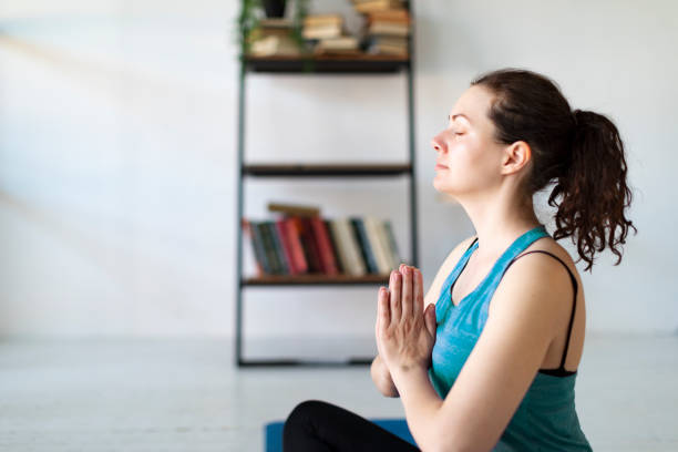 istock Young woman practicing yoga at home 1403533957