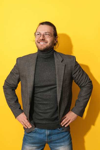 istock Handsome bearded man wearing  glasses smiling on  yellow background 1403535176