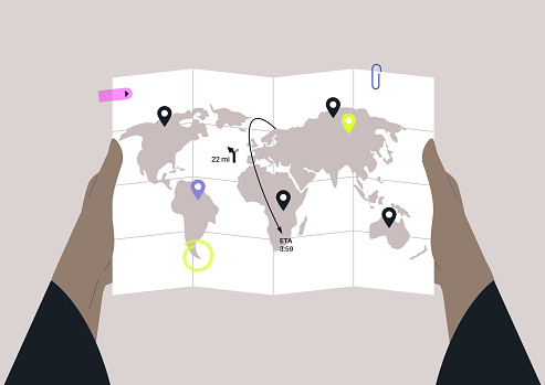 Hands holding a global map with folding lines and geo pins, travel concept