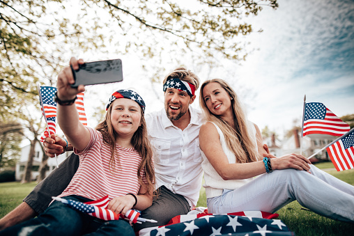 family doing a picnic for the fourth of july and take a selfie