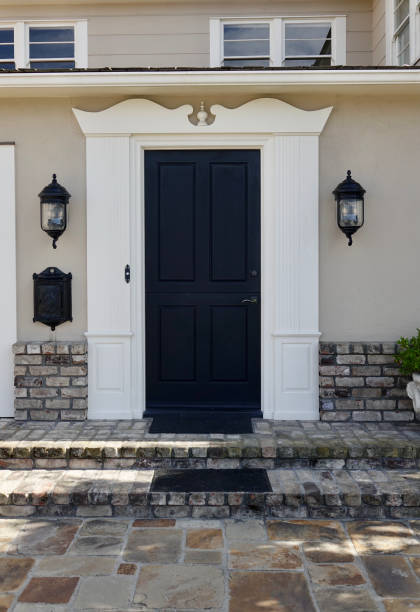 istock Traditional style brick home glossy black front door 1403537435
