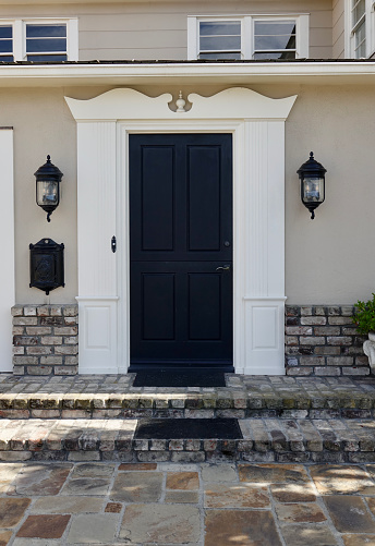 Traditional style brick home with glossy black front door