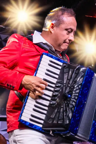 Hispanic accordionist performing in a concert