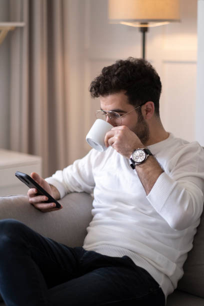 istock Portrait of a cheerful man using smart phone at home office. 1403541372