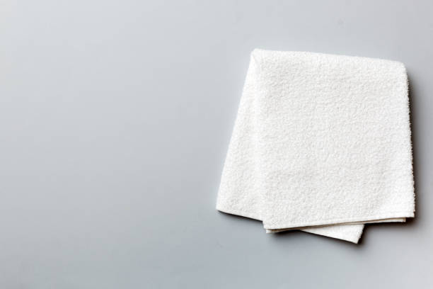 istock Top view of white towels with copy space on colored background 1403551744