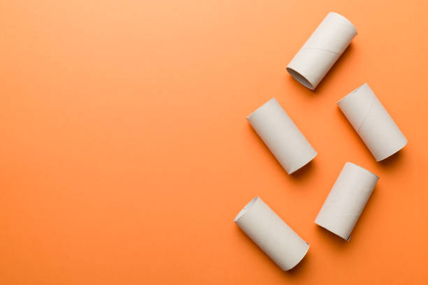 istock Flat lay composition with empty toilet paper rolls and space for text on color background. Recyclable paper tube with metal plug end made of kraft paper or cardboard 1403551750