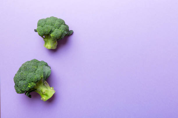 istock Top view fresh green broccoli vegetable on Colored background. Broccoli cabbage head Healthy or vegetarian food concept. Flat lay. Copy space 1403551816