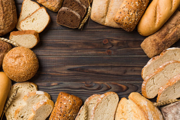 Homemade natural breads. Different kinds of fresh bread as background, top view with copy space stock photo