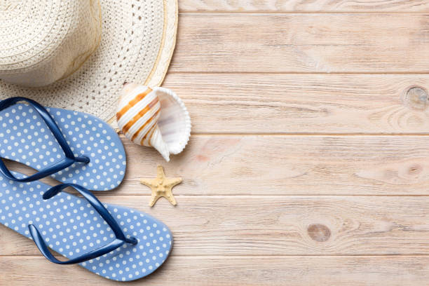 istock Summer travel concept. Flip flops, summer hat and starfish on white. Top view on colored background 1403552578