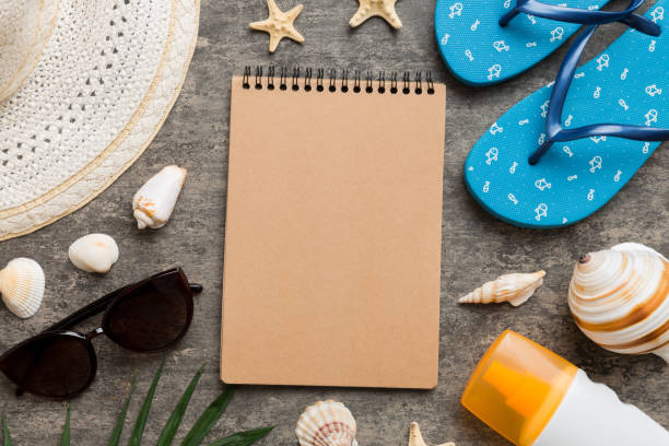 istock Blank writing book with summer beach accessories on background, copy space. Flat lay with copy space 1403552614