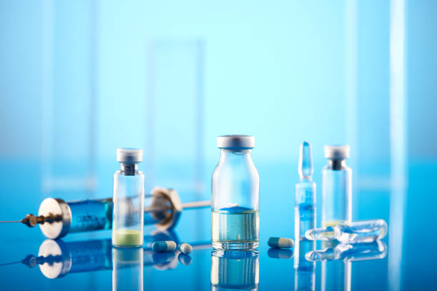 istock Coronavirus Vaccine: Syringe And Vials On Blue Background 1403555758