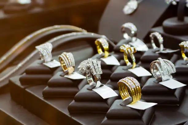 Photo of jewelry diamond rings show in luxury retail store window display showcase